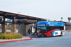 Passengers boarding the RTA Route 1 bus at the Vine Mobility Hub in Downtown Riverside.