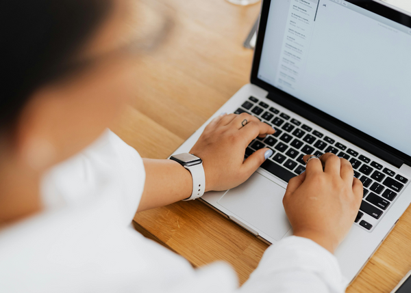 Person shown using a laptop and typing an email